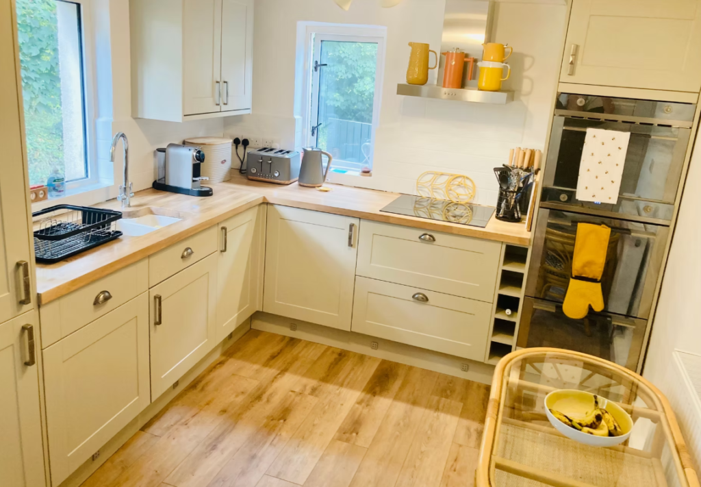 Boyne House, Pembrokeshire 1 Cream kitchen at Boyne House with wooden worktops, built-in ovens and a coffee machine
